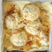 Apricot Crumble Semifreddo sits in a square metal tin on a light grey background.