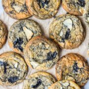 Swirled White Chocolate Black Sesame Cookies lay on parchment paper.