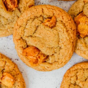 Cornflake cookies sit on a light gray surface.