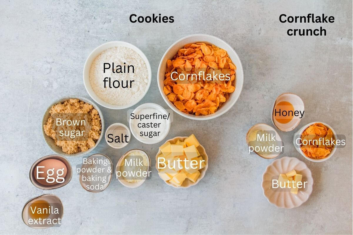 Ingredients forCornflake Cookies sit in a series of bowls on a gray surface.