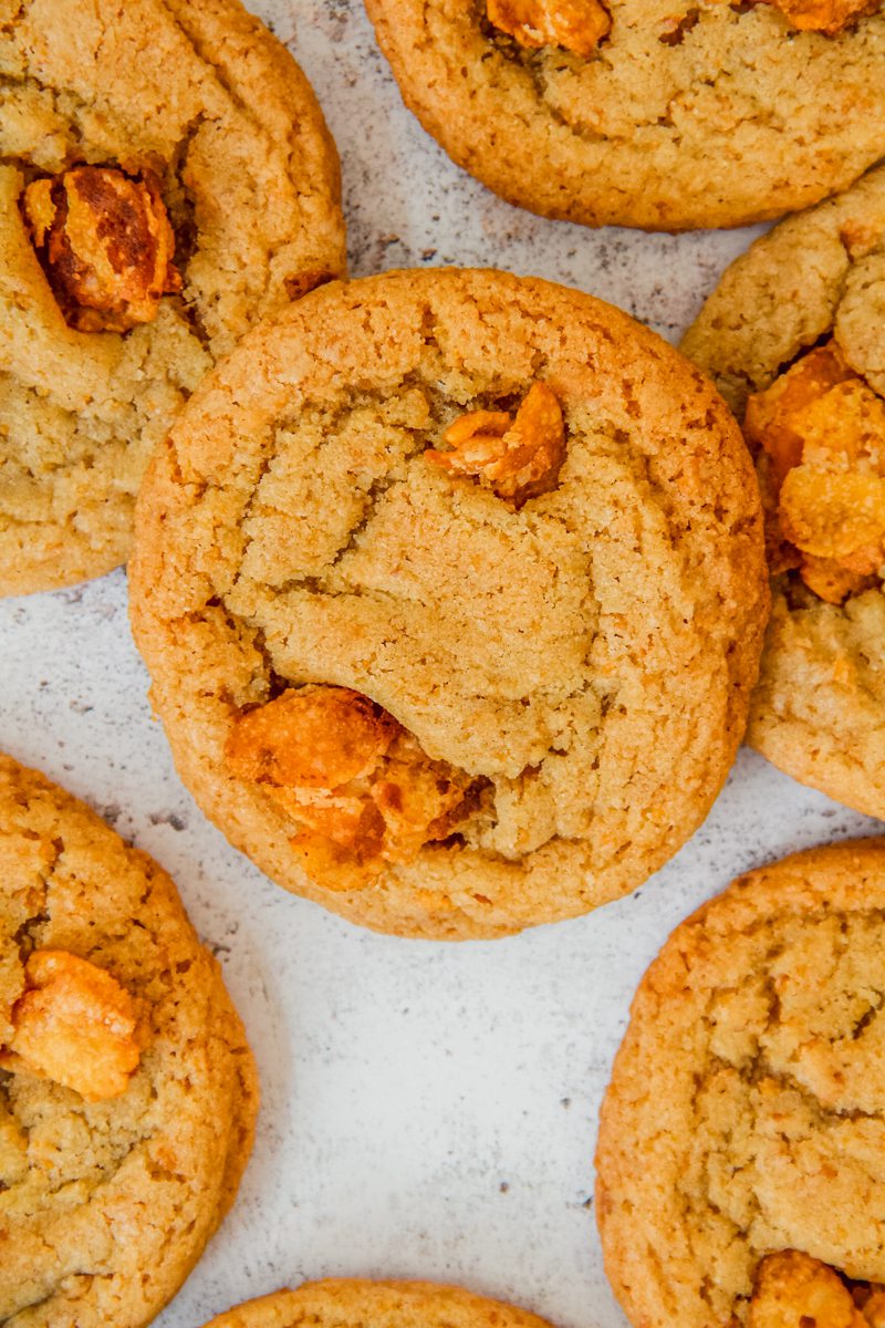 Cornflake cookies sit on a light gray surface.