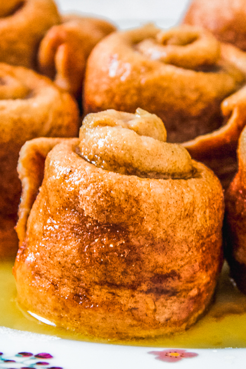 A close up of a Dutch Ginger Roll with it's glazed appearance sitting in sauce.