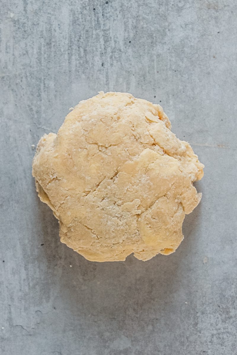 Quiche dough sits on a gray surface.