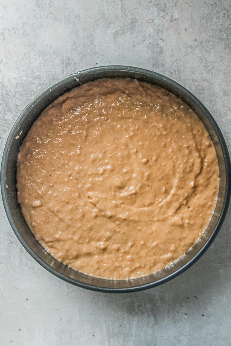 Irish Oatmeal cake batter sits in a round cake tin prior to baking.