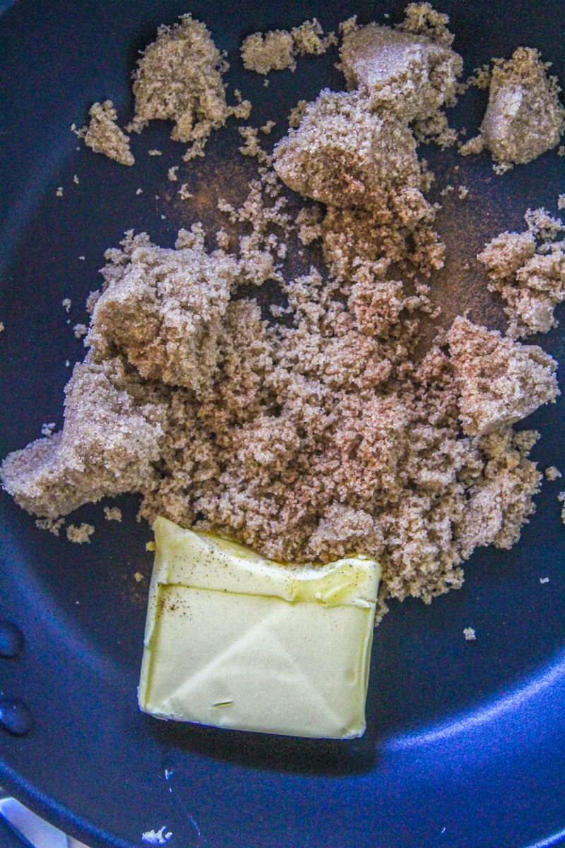 Ground cinnamon, butter and brown sugar sit in a saucepan.