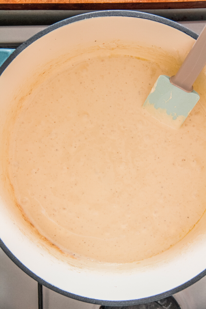 Melted marshmallows and browned butter sit in a Dutch oven on a cooker.