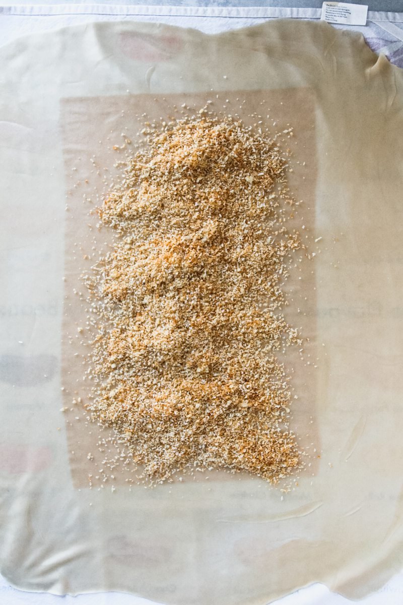 Breadcrumbs sit in the center of thin apple strudel pastry.