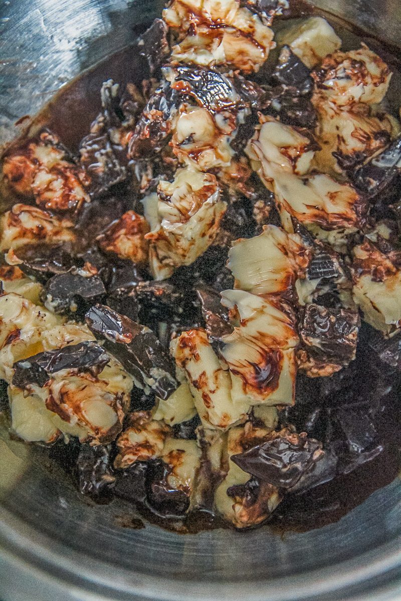 Butter and chocolate sit in a stainless steel bowl.