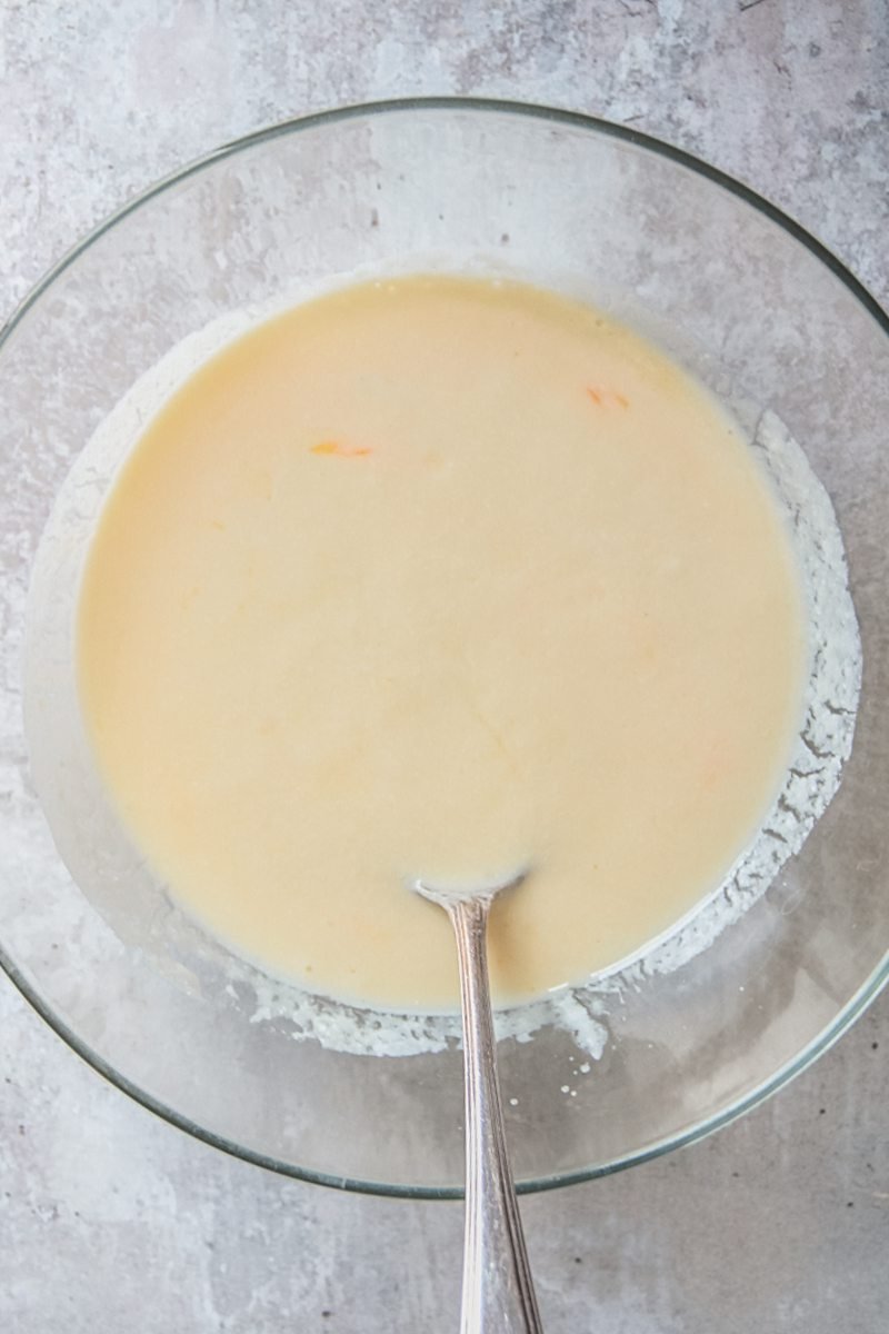 A buttermilk egg mixture sits in a glass bowl on a gray surface.