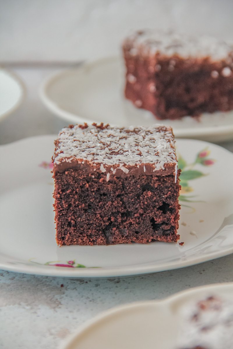 A slice of Icelandic chocolate cake sits on an individual plate on a light gray surface.
