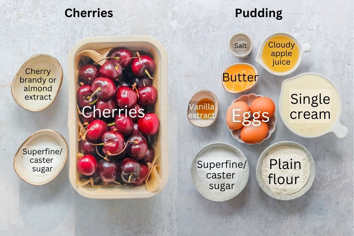 Ingredients for Kentish Cherry Batter Pudding sit in a series of bowls on a gray surface.