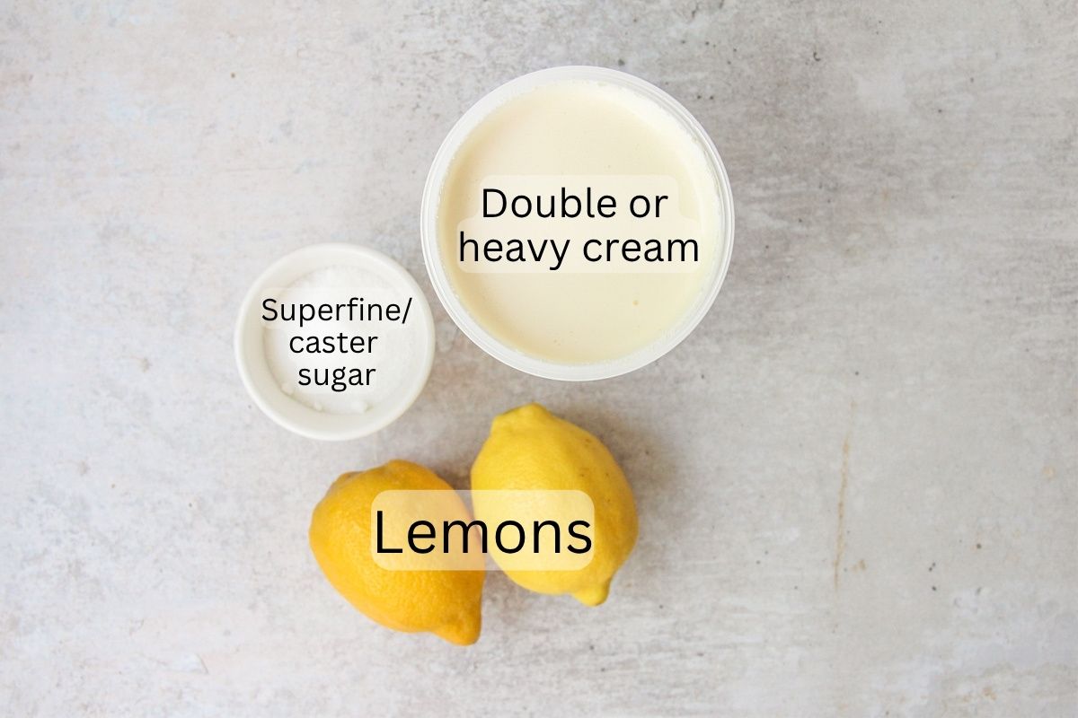 Ingredients for Lemon Posset sit on a gray surface.
