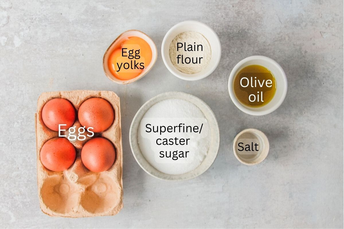 Ingredients for Pao de Lao - Portuguese Sponge Cake sit in a series of bowls on a gray surface.