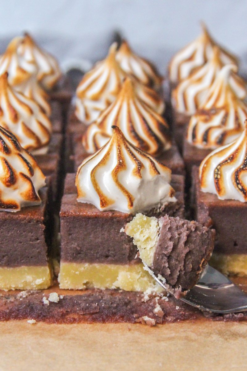 A spoonful of Sweet Potato bar rests on a spoon with the remaining bars sitting behind on parchment paper.