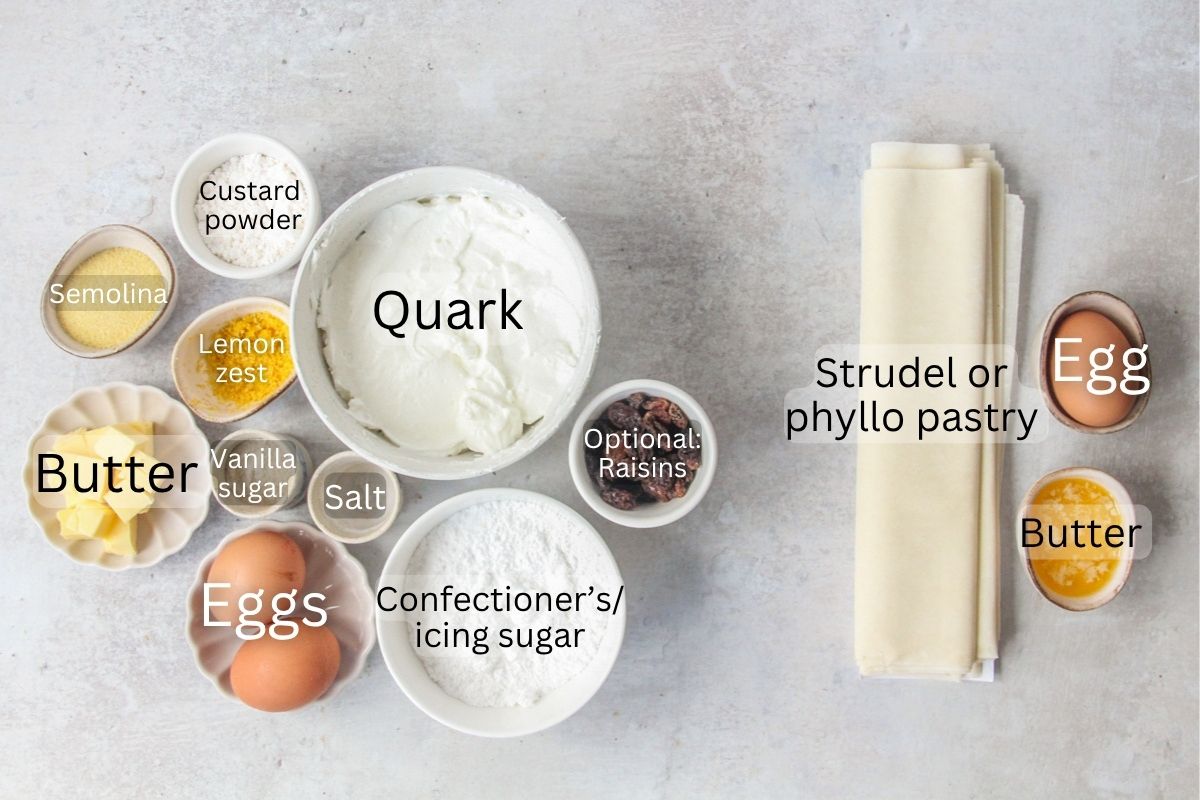 Ingredients for Topfenstrudel - Austrian Cheesecake Strudel sit in a series of bowls and plates on a gray surface.
