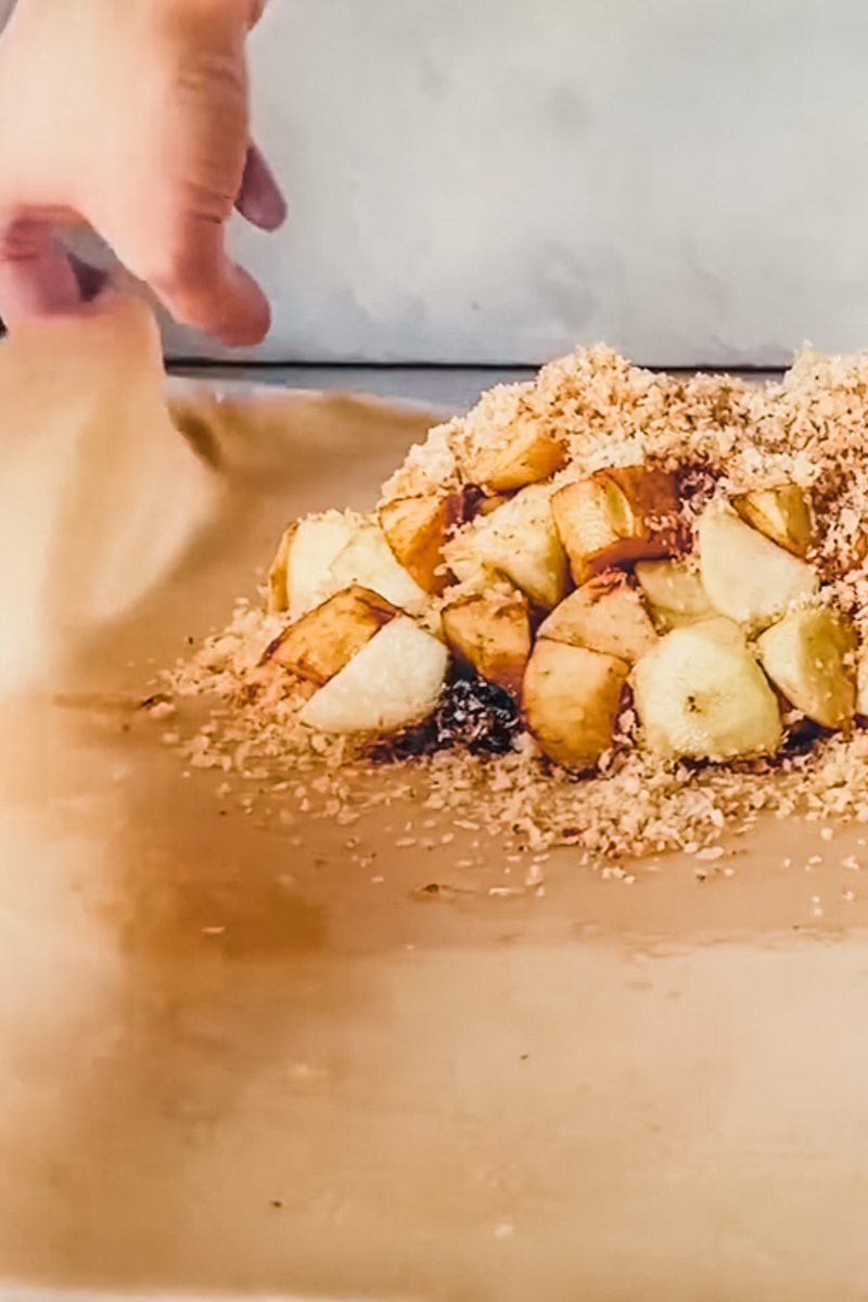 Pastry is foled over the center of apple strudel filling.