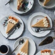 Slices of Butterscotch Pie sit on individual plates on a light grey background.