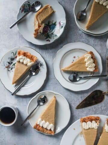Slices of Butterscotch Pie sit on individual plates on a light grey background.