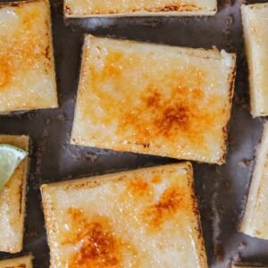 key lime bars sit beside each other with caramelized tops visible