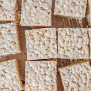 Rice Krispie treats sit on parchment paper.